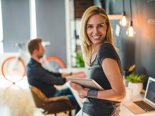 Beautiful businesswoman holding a digital tablet in a design studio.